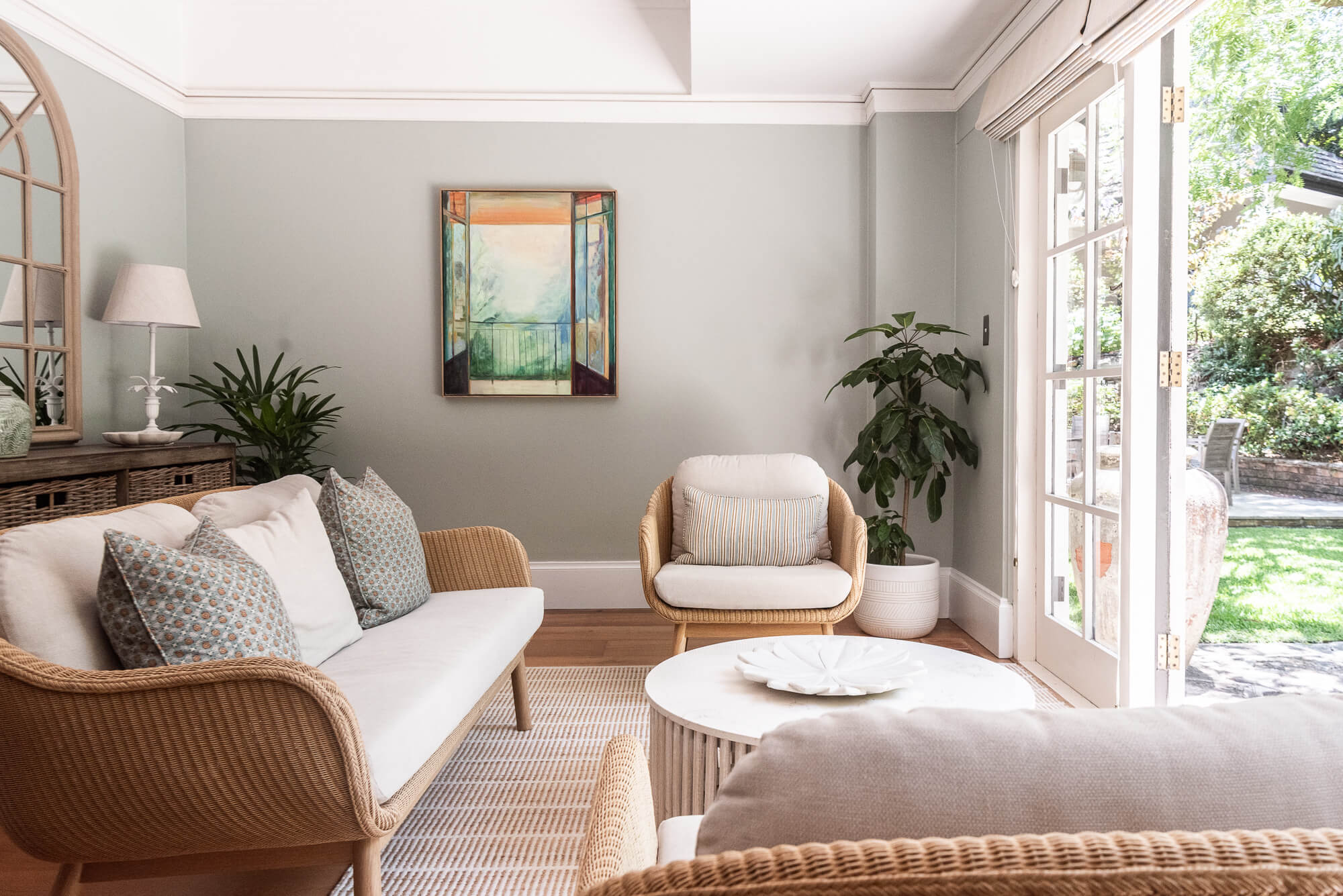 Living room with wicker sofa, armchair, and coffee table.