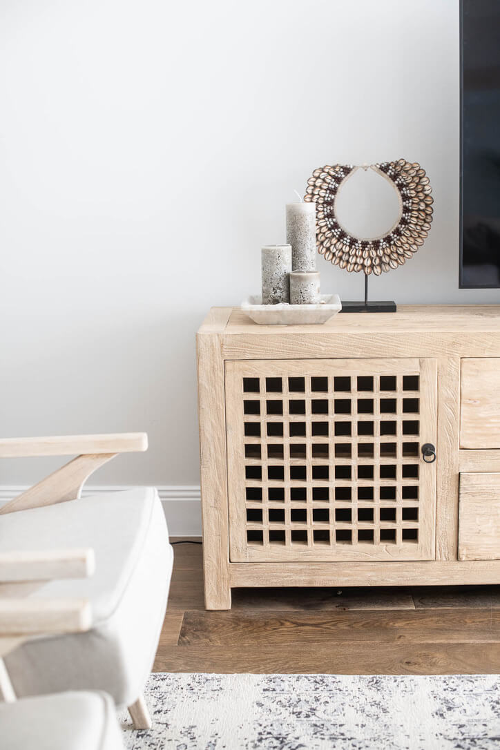 Wooden elm cabinet with decorative items in a living room setting