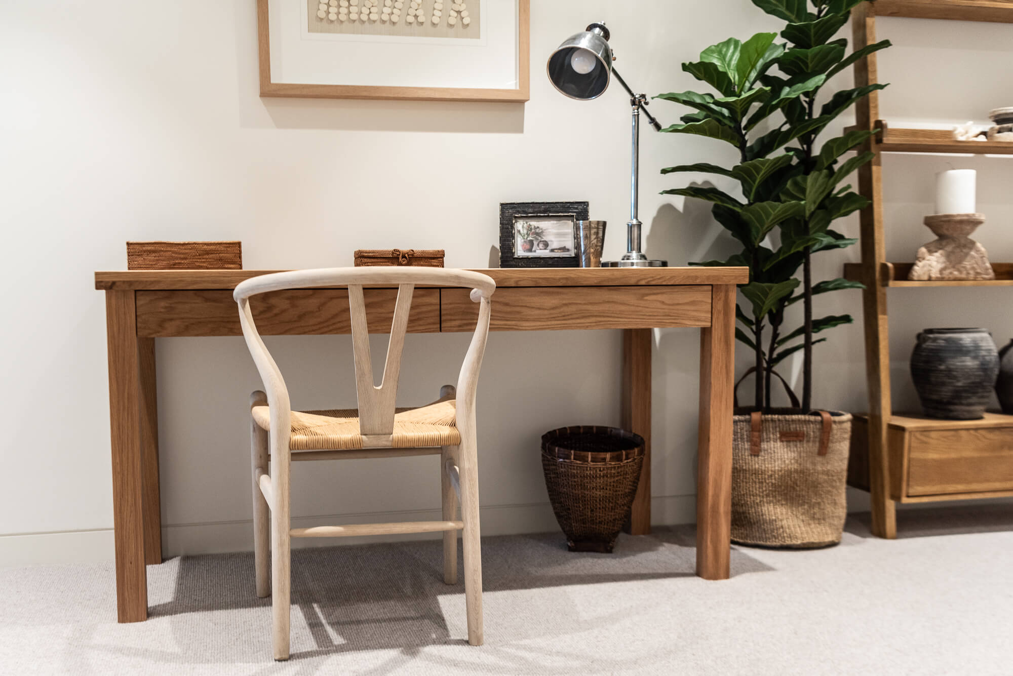 Wooden desk with chair in a room with decor elements