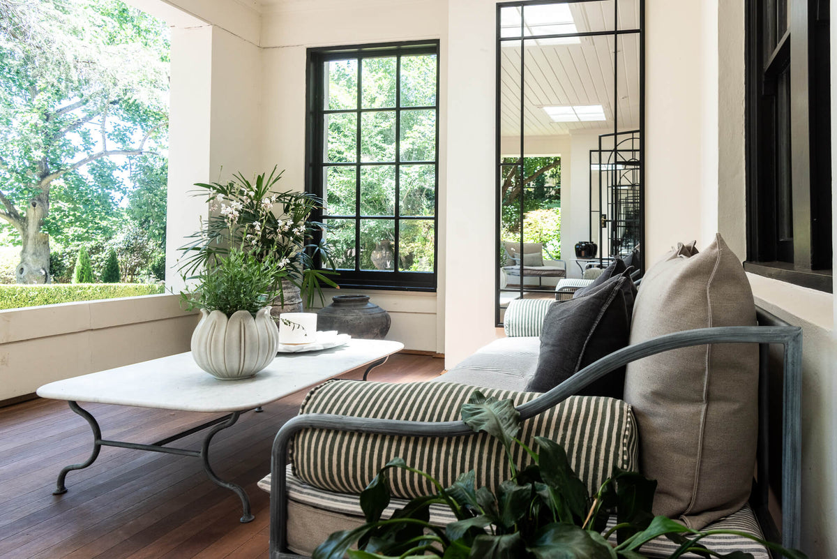 Modern living room with a sofa, coffee table, and decorative elements.