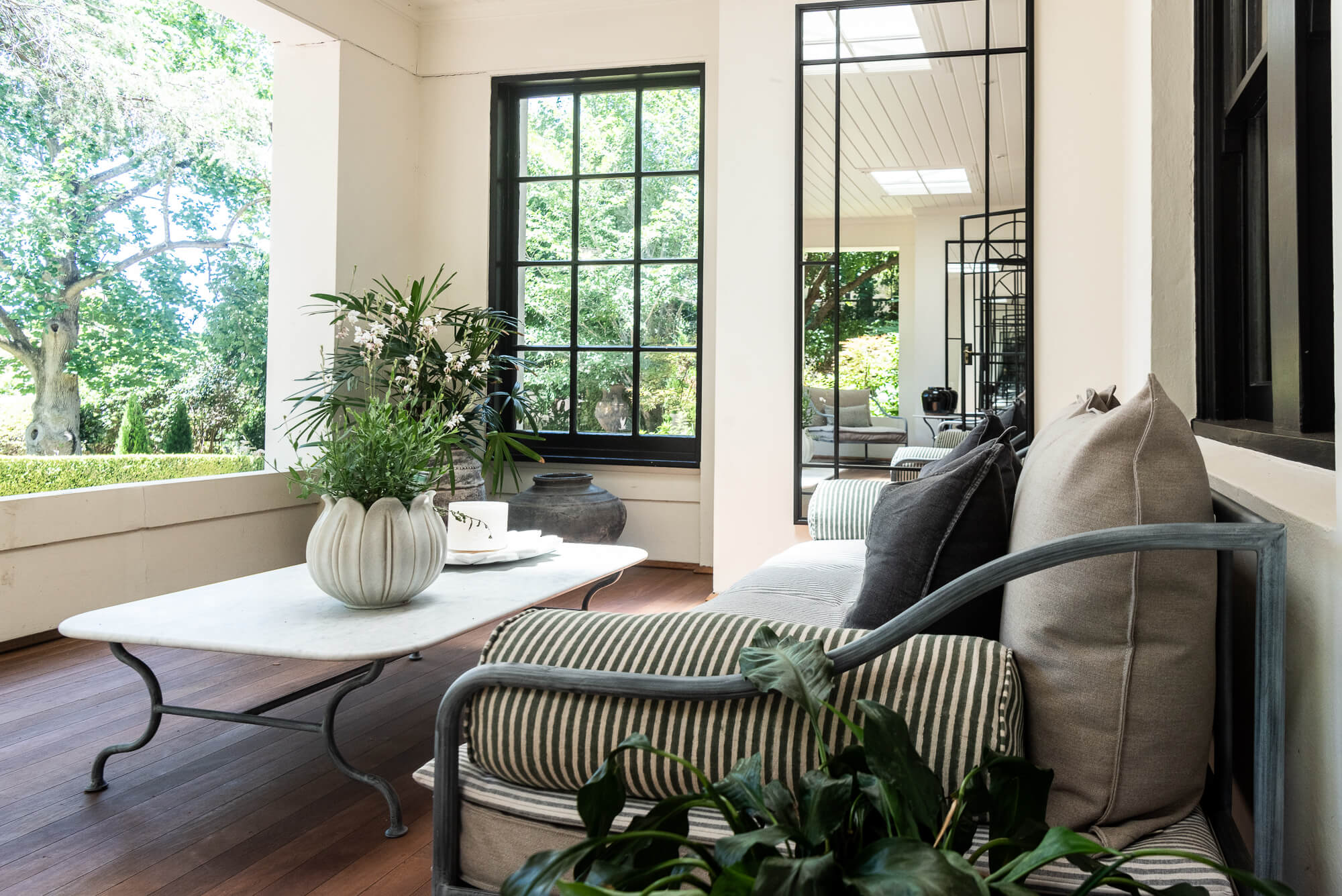 Modern living room with a sofa, coffee table, and decorative elements.